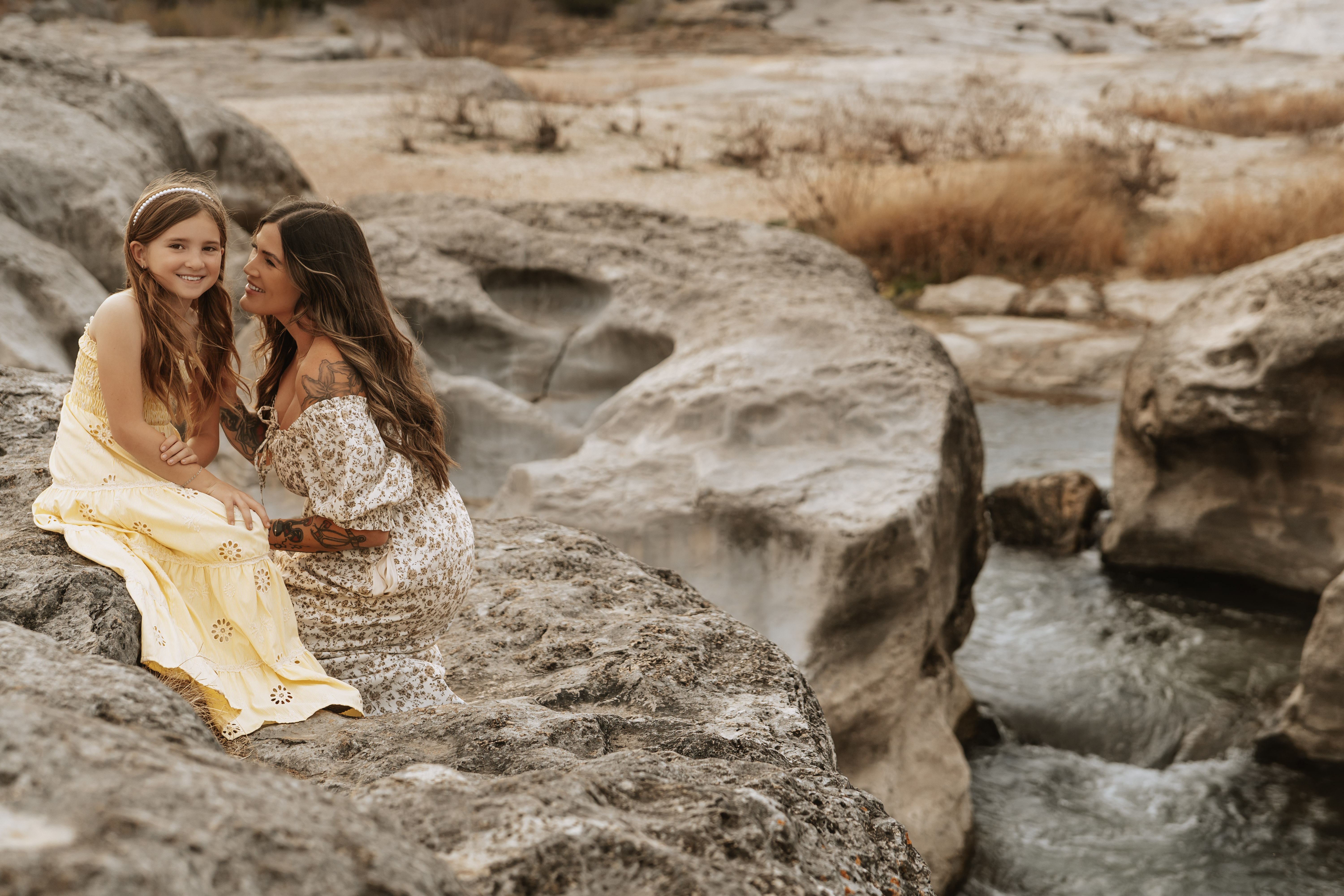 A mother tenderly holds her newborn, captured by Soul Sacred Photography